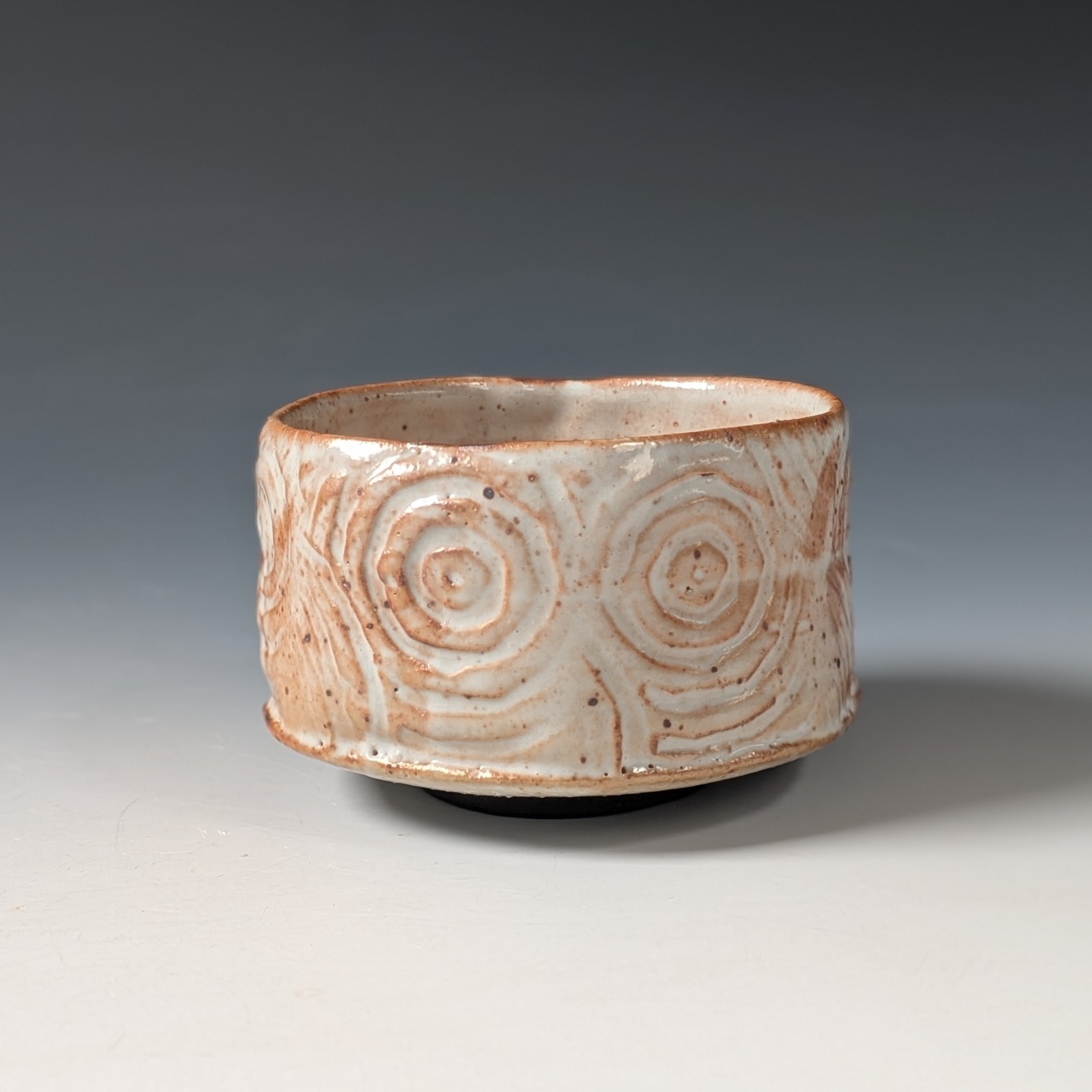 a shino glazed tea bowl fired in a saggar